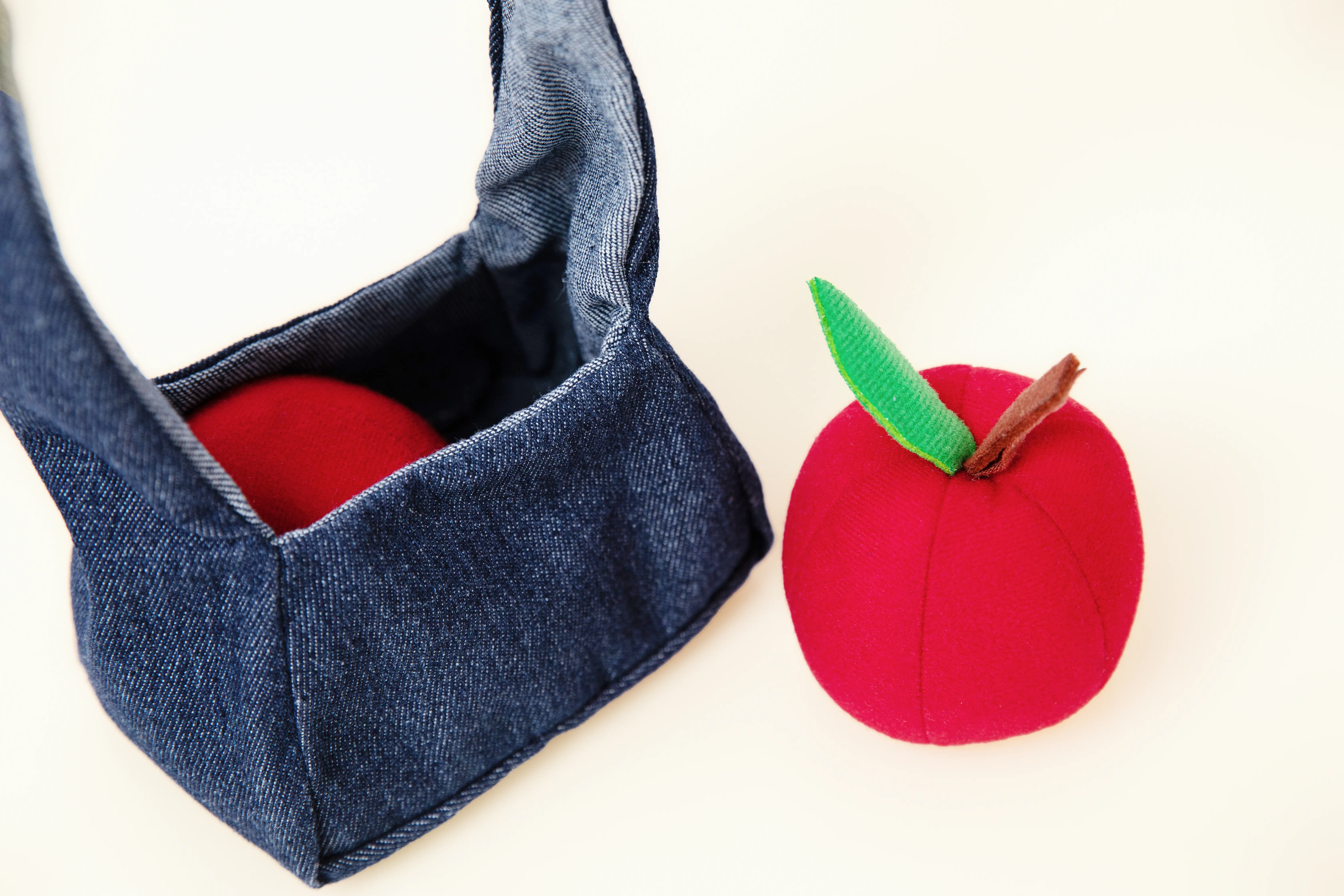 Soft apple and denim bag used for language play